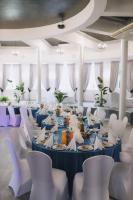 a long dining room with blue tables and white chairs at Szafir in Rzeszów