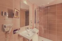 a bathroom with a sink and a shower with a mirror at Best Western Plus Richelieu in Limoges