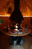 a kitchen with a table with plates of food on it at Les Cabanes De Pyrene in Cazarilh