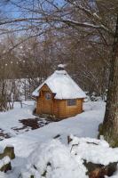a small wooden cabin with snow on top of it at Les Cabanes De Pyrene in Cazarilh
