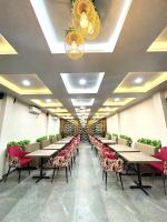 a dining room with tables and chairs and lights at Arka Hotel and Restaurant in Lakhipur