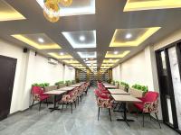 a row of tables and chairs in a restaurant at Arka Hotel and Restaurant in Lakhipur