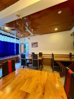 a conference room with wooden tables and chairs at New Hotel Rhino in Guwahati