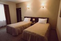 a hotel room with two beds with white pillows at C&C Residence Hotel in Bacău