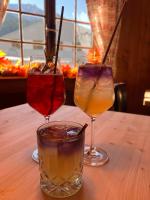 three glasses of drinks sitting on a table at Sonne in Klosters