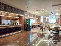 a restaurant with a bar and tables and chairs at The Dome Grand in Ninh Lão