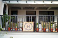 a balcony with chairs and a sign on a railing at The Hush Nepal in Kathmandu