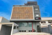 a building with a qoin sign on the side of it at Super Hotel O Golden Tulip'z in Gorakhpur