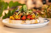 a piece of bread with vegetables on it on a plate at Mercure Darwin Airport Resort in Darwin