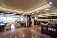 a restaurant with tables and chairs in a room at The Enterpriser Hotel in Taichung