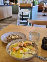 a bowl of food on a table with a plate of food at Hotelli Savonlinna in Savonlinna