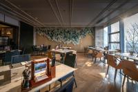 Un comedor con mesas y sillas y un escritorio. en Wuhan Marriott Hotel Wuchang, en Wuhan