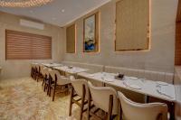 a row of tables and chairs in a room at Hotel Warma Palace in Yeola