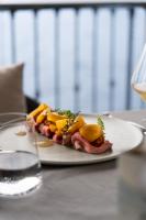 a plate of food with meat and vegetables on a table at Relais Villa Porta in Luino