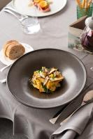 a plate of food on a table with a piece of bread at Relais Villa Porta in Luino