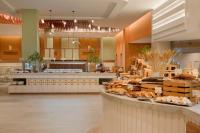 a large kitchen with a counter with food on it at Iberostar Selection Rose Hall Suites - All Inclusive in Montego Bay