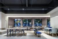 a dining room with tables and chairs and windows at Atour Light Hotel Shanghai Minhang Maqiao in Shanghai