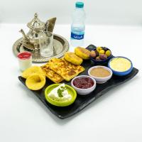 a tray of food with bread and other foods on it at Hotel Maram in Tangier