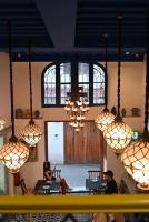 a group of people sitting in a room with chandeliers at Hotel Maram in Tangier