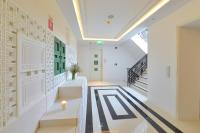 a hallway with white walls and a staircase at Riva Arun Bangkok in Bangkok