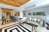 a living room with a couch and a table at Riva Arun Bangkok in Bangkok