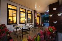 a restaurant with chairs and tables and windows at Love in Hualien B&amp;B in Hualien City