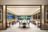 a dining room with tables and chairs and windows at Atour Hotel Sun Moon Light Dapu Bridge,Shanghai in Shanghai