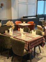 a dining room with two tables and chairs at AMANA Hotel Phan Thiet in Ấp Bình Hưng