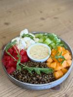 Un plato de comida con garbanzos y verduras y una salsa en Hotel Le Belmont, en Belmont-Tramonet