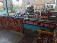 a table with a sign that says help your sell at Bob Marley Peace hotel luxor in Luxor