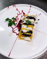 a white plate with a piece of food on it at Hotel Landgasthof Weingut Seeperle in Caldaro