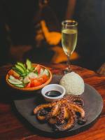 Un plato de comida con una copa de vino y un plato de comida con camarones en Casa A'more, en Cuatunalco