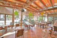 a restaurant with tables and chairs and windows at Hotel Restaurant Freihof in Oberharmersbach