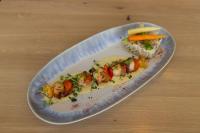 a plate of food with shrimp and rice on a table at Hotel De La Mer in Quiberon