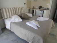 a bed with two white towels on top of it at Theofanis Studios in Agia Anna Naxos
