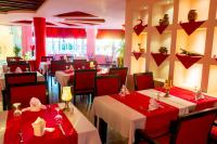 a restaurant with tables with red tablecloths at Studio in Nubia Aqua Beach Twin Room in Hurghada in Hurghada