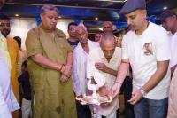 Eine Gruppe Männer steht um einen Mann herum, der einen Kuchen hält. in der Unterkunft Hotel BLUE DIAMOND in Begusarai