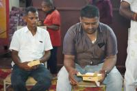 Zwei Männer saßen da und hielten Kisten in ihren Händen. in der Unterkunft Hotel BLUE DIAMOND in Begusarai