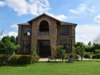 een groot bakstenen gebouw met een raam bij Amaris Greens Resort by CYJ in Belparāo