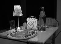 a table with a glass plate and a bottle on it at Irroi Kaziranga in Kāziranga