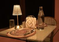 a glass table with a plate and a bottle on it at Irroi Kaziranga in Kāziranga