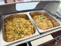 twee metalen schalen met voedsel in een oven bij Vangvieng Sisavang Hotel in Vang Vieng