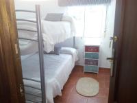 a bedroom with two bunk beds and a window at Mirador de Mulera in Ubrique