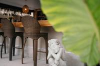 a statue sitting on a chair next to a table at TALI BOUTIQUE Hotel in Ao Nang Beach
