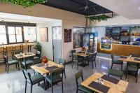 a restaurant with wooden tables and chairs and a counter at Kilimani Chic Studio in Nairobi