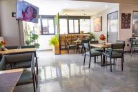 a dining room with tables and chairs in a restaurant at Kilimani Chic Studio in Nairobi