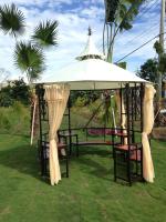 a gazebo with chairs under a white umbrella at Sophia B&amp;B in Dongshan
