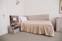 a bedroom with a large bed and a lamp on a night stand at C&C Residence Hotel in Bacău