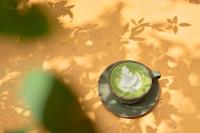 a cup of coffee on a plate on a table at Thong Dong Quán Boutique Hotel Hue in Hue