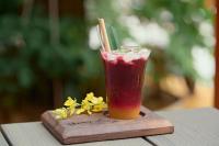 a drink is sitting on a wooden cutting board at Thong Dong Quán Boutique Hotel Hue in Hue